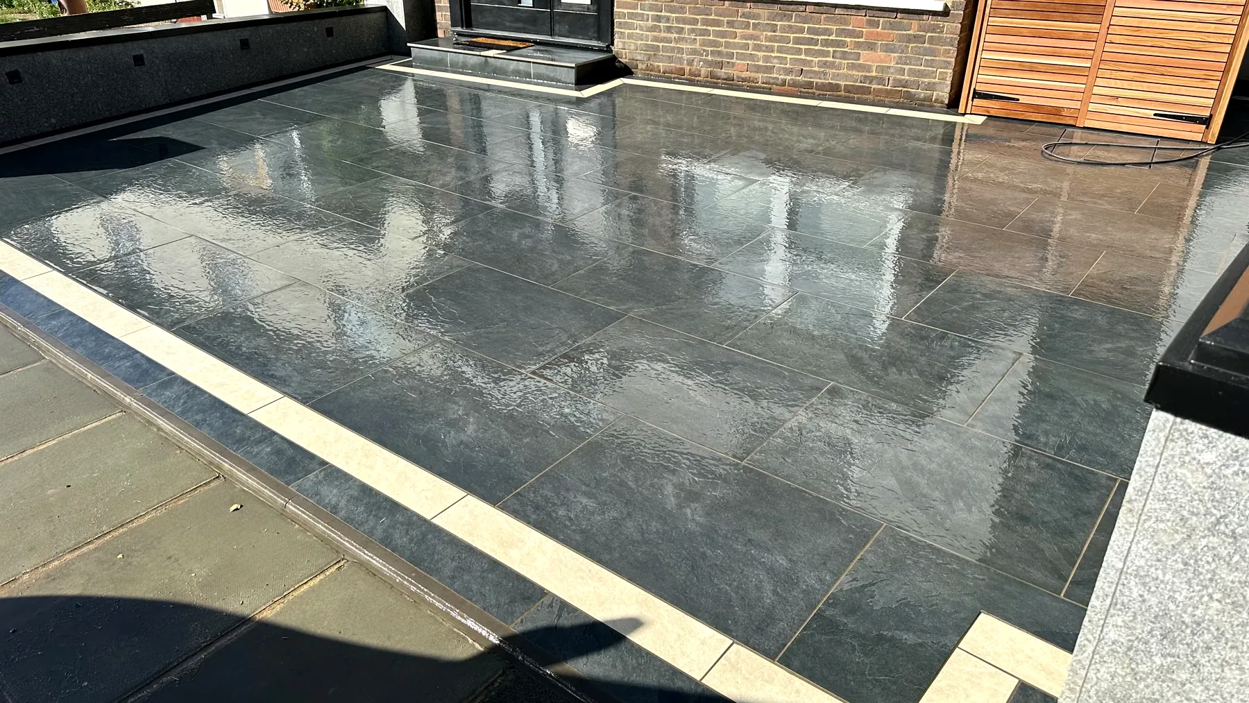Completed dark grey paving with a light contrasting border